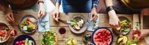Friends gathered over a table of good food cropped2