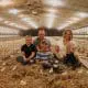 farm family in chick barn