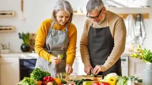 couple cutting vegetables