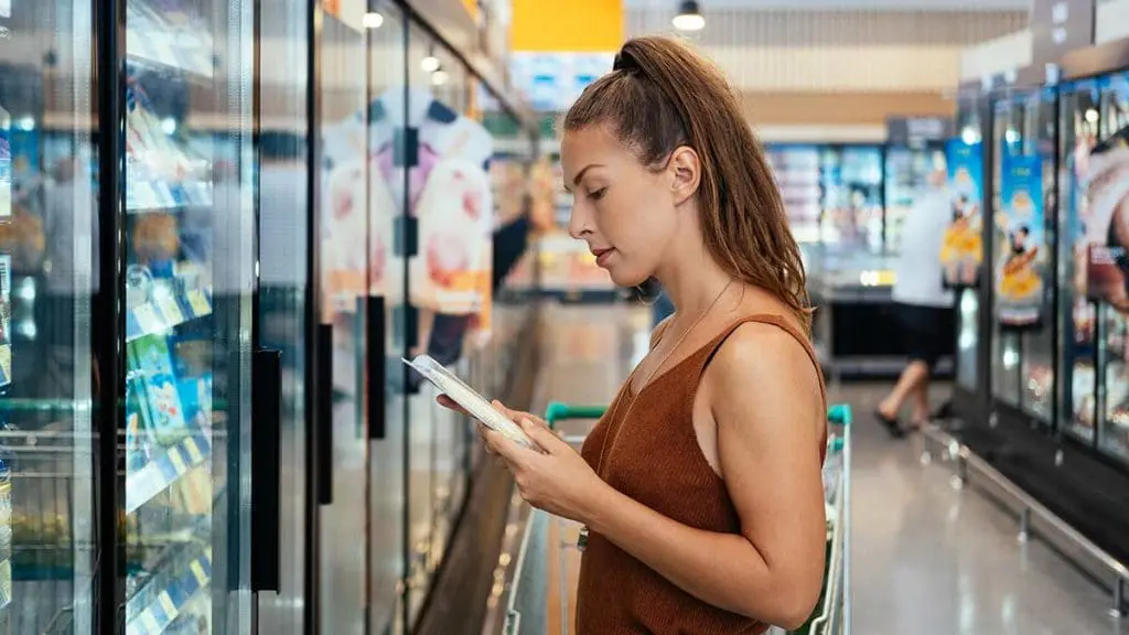 woman reading food label