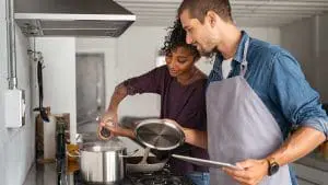 man and woman cooking
