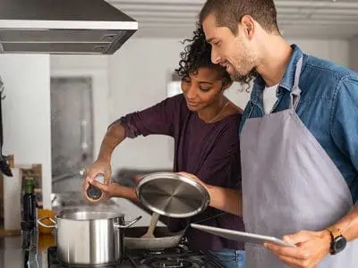 man and woman cooking