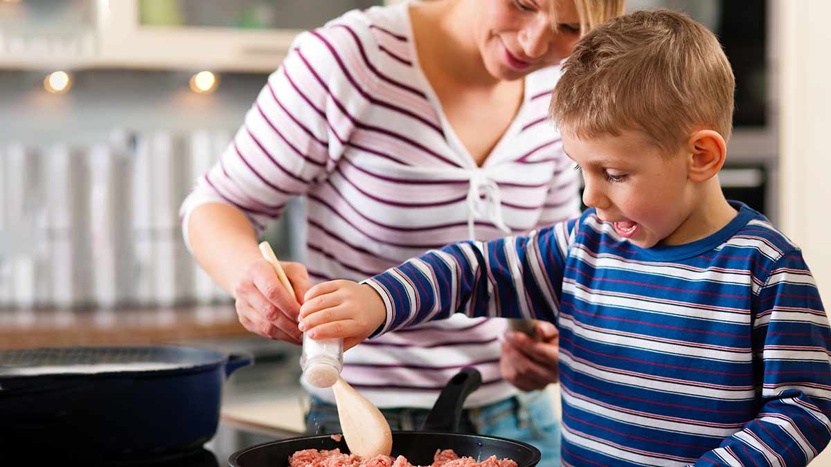 child and parent cooking