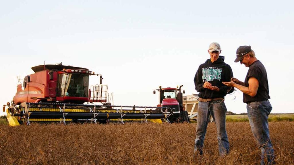 farmer and son in field